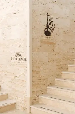 a set of stairs with a sign on a wall at Rich Collective in Nesebar