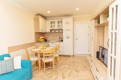 a living room with a blue couch and a table at Burgas Beach Resort Apartments in Burgas City