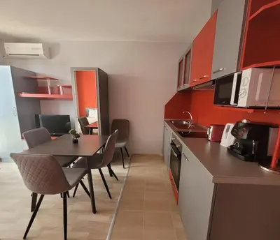 a kitchen with a table and chairs in a room at Sirena Holidays in Ravda