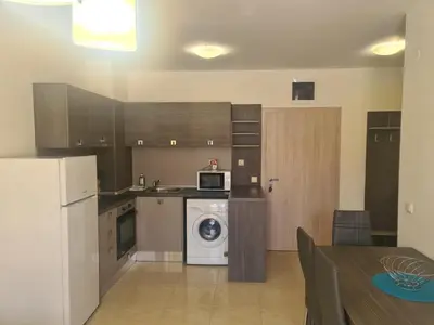a kitchen with a refrigerator and a washer and dryer at Private Apartment in Star Dreams Complex in Sveti Vlas