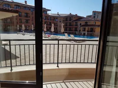 a balcony with a view of a pool and buildings at Private Apartment in Star Dreams Complex in Sveti Vlas