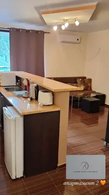 a kitchen with a counter top with a sink at Atliman Beach Apartment 1 in Kiten