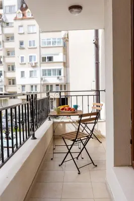 a balcony with a table and chairs on it at Apartments Flora in Burgas City