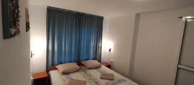 a bedroom with a bed with two pillows on it at Rooms Via Maris in Sozopol