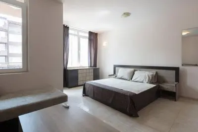 a bedroom with a large bed and a window at Santa Sofia Studio in Sunny Beach