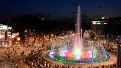 a fountain in the middle of a city at night at Cathedral Guesthouse in Varna City