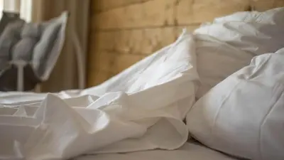 a bed with white sheets and pillows on it at The Mint Villa - Saint Vlas in Sveti Vlas