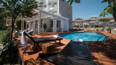 a swimming pool with a bench next to a building at The Mint Villa - Saint Vlas in Sveti Vlas
