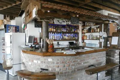 a bar in a restaurant with a brick wall at Aleksandrovo Apartments in Aleksandrovo