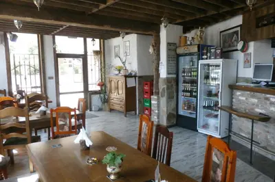 a kitchen with a table and a refrigerator at Aleksandrovo Apartments in Aleksandrovo