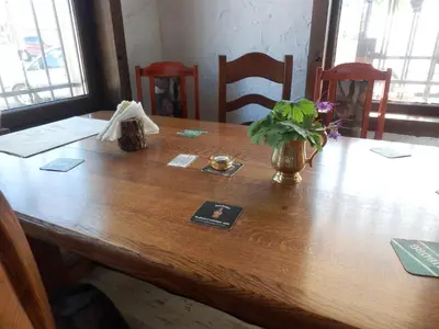 a wooden table with a vase of flowers on it at Aleksandrovo Apartments in Aleksandrovo