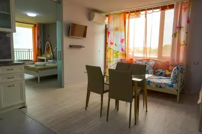 a kitchen and dining room with a table and chairs at Studios Grace - Port Tsarevo in Tsarevo