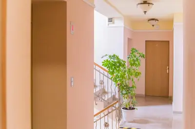 a hallway with a staircase and a potted plant at Apartments Iris69 in Varna City
