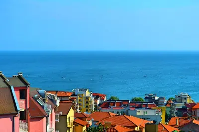 a group of buildings with the ocean in the background at Joro Guest House in Sveti Vlas