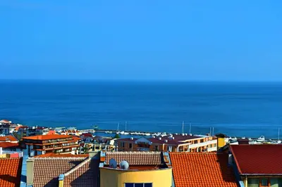 a view of roofs of houses and the ocean at Joro Guest House in Sveti Vlas