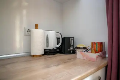 a counter top with a coffee maker and a coffeemaker at The Cozy Apartment in Varna City