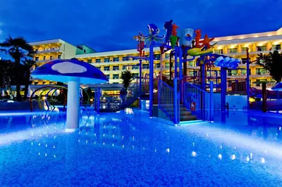a swimming pool with a playground in front of a building at DIT Evrika Beach Club Hotel - All Inclusive in Sunny Beach