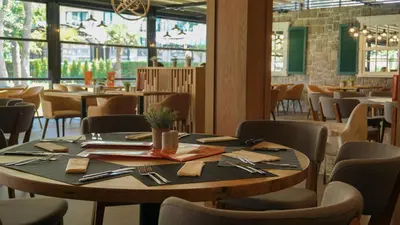 a dining room with a wooden table and chairs at DIT Evrika Beach Club Hotel - All Inclusive in Sunny Beach