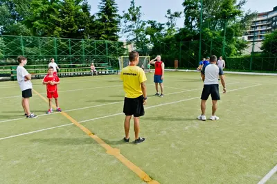 a group of people standing on a tennis court at DIT Evrika Beach Club Hotel - All Inclusive in Sunny Beach