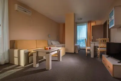 a living room with a couch and a table at Aparthotel Hotel Prestige City II in Primorsko