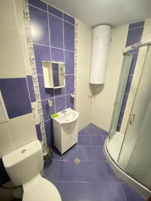 a bathroom with a toilet and a sink and a shower at Holidays apartment Bourgas in Burgas City