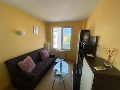 a living room with a black couch and a glass table at Holidays apartment Bourgas in Burgas City