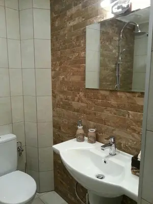 a bathroom with a sink and a toilet and a mirror at Florata apartment in Burgas City