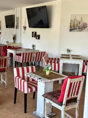 a dining room with red and white chairs and a table at Lozenets View Hotel in Lozenets