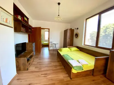 a room with a bed and a tv in it at ART Apartments - Pomorie in Pomorie