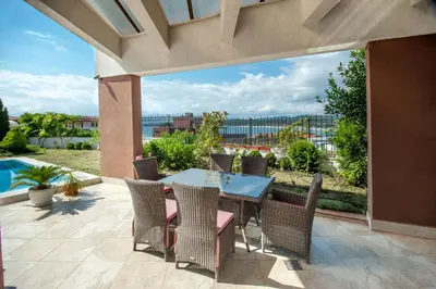 a patio with a table and chairs and a view at Luxury House on Buzhaka in Sozopol