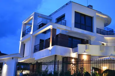 a white apartment building with lights on at Luxury House on Buzhaka in Sozopol