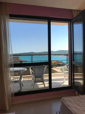 a room with a balcony with a view of the ocean at Luxury House on Buzhaka in Sozopol