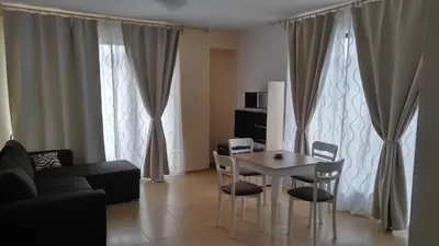 a living room with a table and chairs and a couch at Boulevard Sea Residence in Sunny Beach