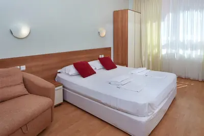a bedroom with a large bed and a couch at Pollo Resort in Sunny Beach