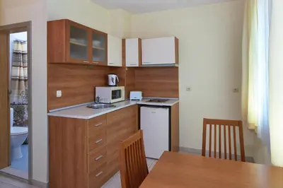 a small kitchen with a sink and a table at Pollo Resort in Sunny Beach