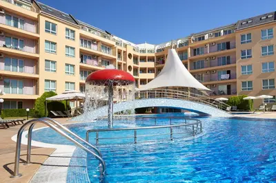 a swimming pool in front of a large building at Pollo Resort in Sunny Beach