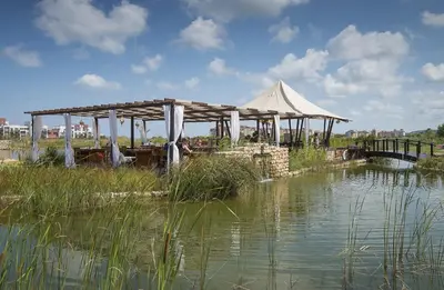 a pavilion over a body of water with a bridge at Sunrise All Suites Resort- All Inclusive in Obzor