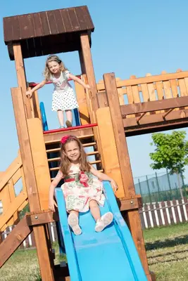 two little girls on a slide at a playground at Sunrise All Suites Resort- All Inclusive in Obzor
