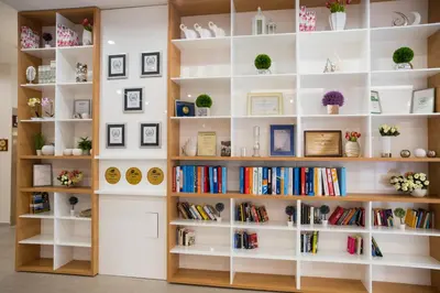 a library with white shelves filled with books at Hotel Laguna Park & Aqua Club - All Inclusive in Sunny Beach