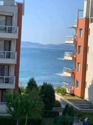 a view of the ocean from between two buildings at Apartments Helios in Pomorie