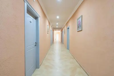an empty hallway with an open door and a long corridor at Hotel Riva Park - All Inclusive in Sunny Beach