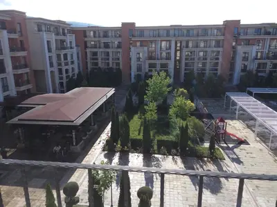 a view of a courtyard with trees and buildings at Sea View Apartment PRESTIGE FORT BEACH , PREMIER FORT BEACH in Sveti Vlas
