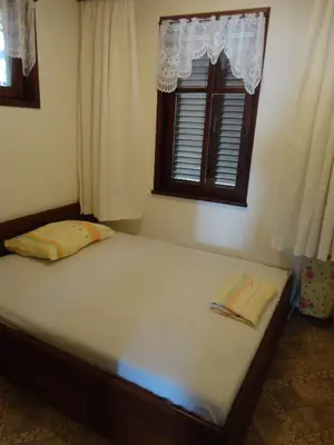a bed sitting in a bedroom with a window at Apartments Anita in Nesebar