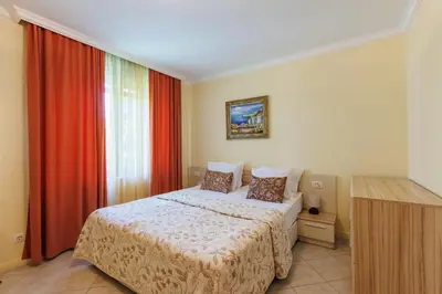 a bedroom with a bed and a window at Apartments DreamBG in Sozopol