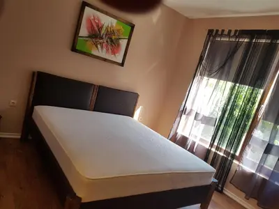 a bed in a room with a window and a bed sidx sidx sidx at Apartments Stefanov in Byala in Byala