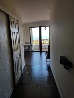a hallway with a door to a room with a view at Apartments Stefanov in Byala in Byala