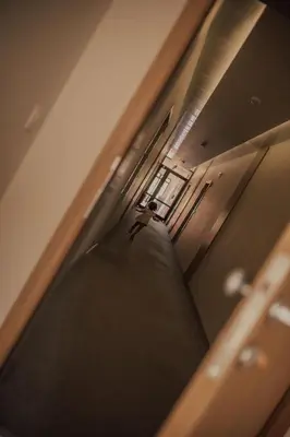 a reflection of a person walking down a hallway at St. Panteleimon Beach Hotel in Nesebar