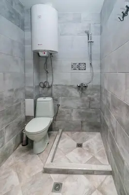 a bathroom with a toilet and a shower at Sea Crib Apartment in Varna City