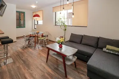 a living room with a couch and a table at Sea Crib Apartment in Varna City