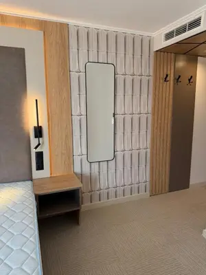 a room with a wall with a mirror on it at Hotel Luxor in Burgas City